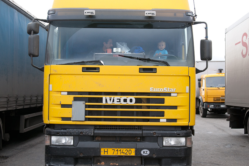 driver_in_cab_truck_and_baby_on_board